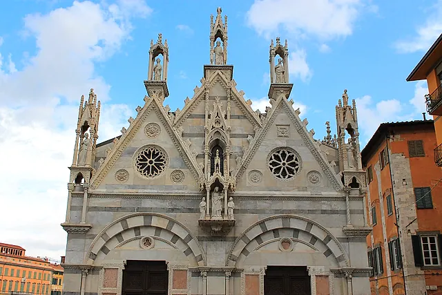 The Gothic façade of Santa Maria della Spina in Pisa, with pointed gables, rose windows and marble pinnacles